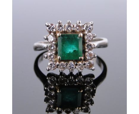  18ct white gold square-cut emerald and diamond cluster ring,
setting width 11mm, size K.