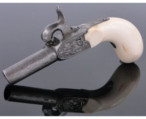 A 19th century miniature percussion muff pistol,
with ivory grip, engraved frame and turnoff barrel with concealed trigger, o