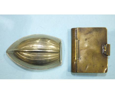 A novelty white metal snuff box in the form of a clinker-built boat, 87 x 48mm and a brass snuff box in the form of a book, 6
