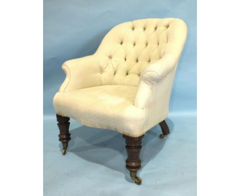 A Victorian mahogany upholstered button-back tub chair on turned front legs with castors.