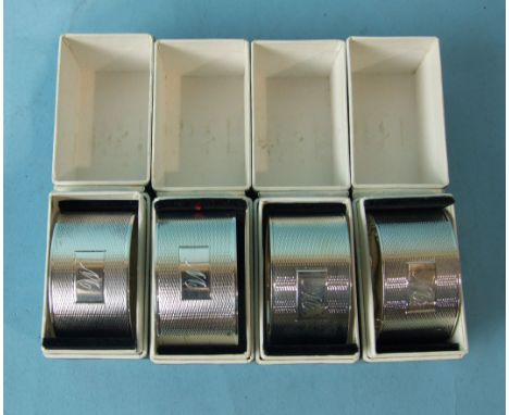 A set of four oval engine-turned napkin rings in boxes, Birmingham 1961, ___7½oz.