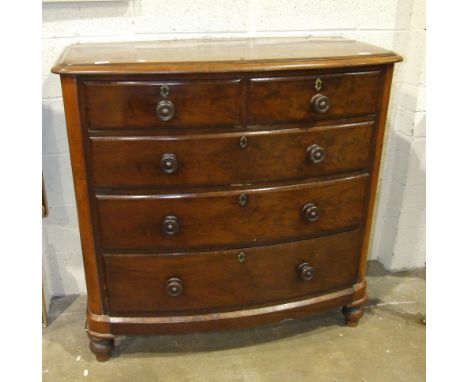 A late-Victorian stained mahogany bow-fronted chest of two short and three long drawers, on turned legs, 111cm wide.