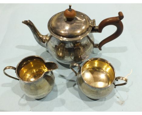 A silver three-piece plain bachelors tea service of bellied form, Birmingham 1931, stamped Wilson &amp; Gill, 15oz.