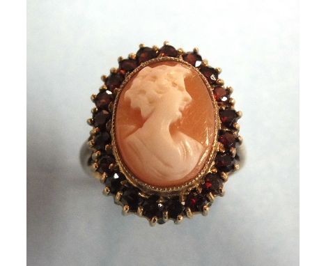 A cameo ring, the shell cameo of a young woman, in garnet-set border, on 9ct gold mount, size K½, 5g.