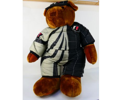 Formula 1 - A large free standing display model Teddy in Formula 1 race suit and cap. He stands approximately 110 cm tall and