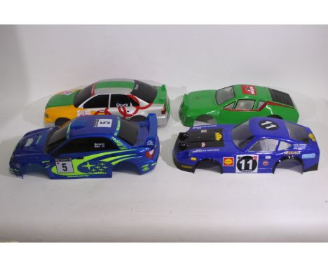 Kyosho - Tamiya - Carson - Other - Four painted and unboxed 1:10 scale RC body shells. Lot consists of a Kyosho Subaru Imprez