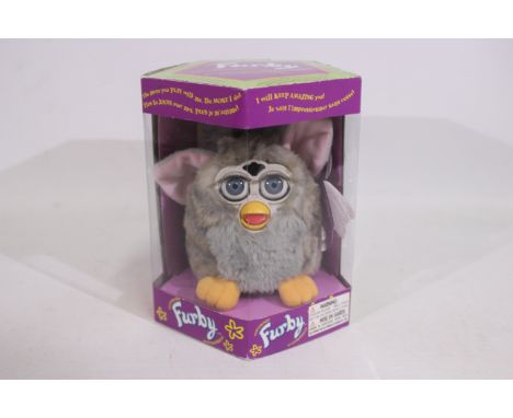 Hasbro - A boxed model #70-800 Generation 2 1998 Electronic Furby with grey fur appears Mint, still attached to its base comp