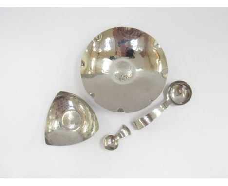 Four pieces of Keswick KSIA/KMC hand planished stainless steel metalware including dish, pin dish, a ladle and caddy spoon 