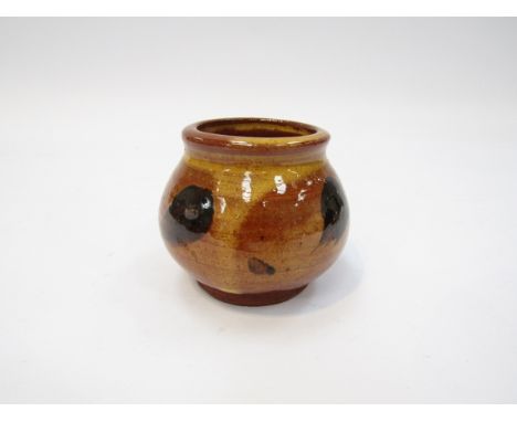 BERNARD LEACH (1887-1979): An earthenware small pot with ochre wash and black splash detail. Impressed personal seal, 5.5cm h