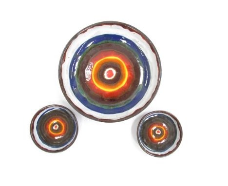 Three circular mid Century ceramic wall hangings with abstract design, one large and one small, possibly West German, unmarke