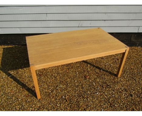 A light oak large coffee table recantangular top, raised on square legs 125cm x 75cm x 52cm high