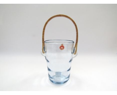 A Per Lutken designed Holmegaard blue tinged glass ice bucket with cane handle. Original paper label.  26cm high including ha