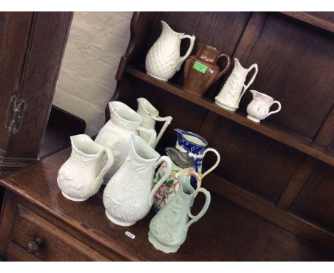 Ten ceramic jugs and one beerstein.