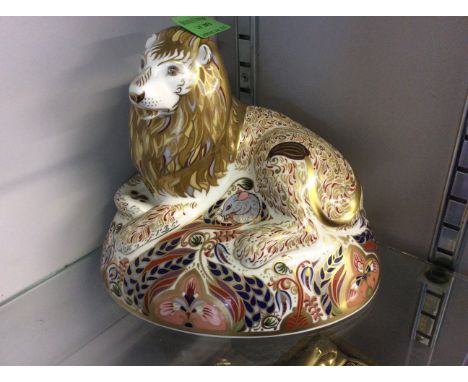 A silver button Royal Crown Derby lion.