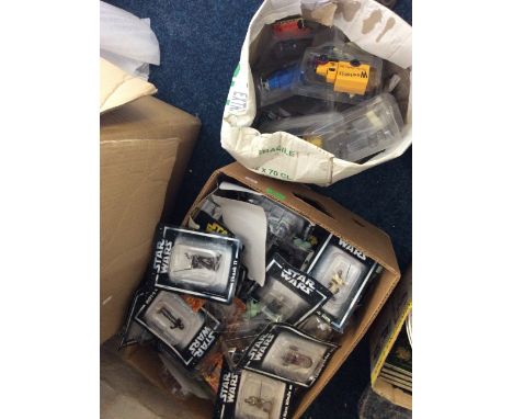 A box of collectable Star Wars figurines along witha box of collectable model vehicles.