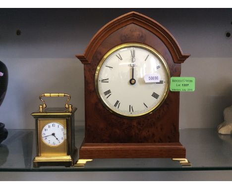 A small brass cased French carriage clock and a reproduction walnut veneered mantle clock.
