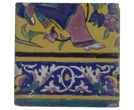A QAJAR POLYCHROME-GLAZED CUERDA SECA TILE of square form, depicting the lower half of a woman and scrolling leafy border, 20