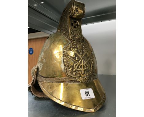 A 19th century brass fireman's helmet (af).