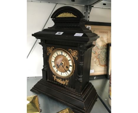 A late 19th century painted wood mantle clock with enamel and metal dial, set with Roman numerals.