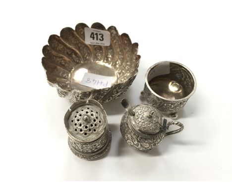 An Indian silver swirl pattern sugar basin with scallop top and a three piece cruet set with floral embossed flowers(262g)