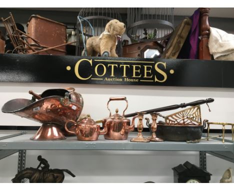 A copper swing handled helmet shaped coal bucket, two copper seamed kettles, two candlesticks, jam pan and other items. 