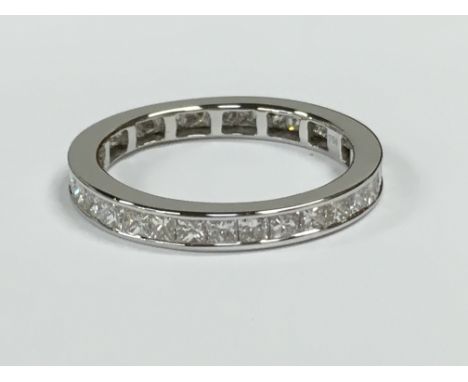 A 18 carat white gold  diamond set princess cut eternity ring, 1.50 carat and VS. Size P/Q.