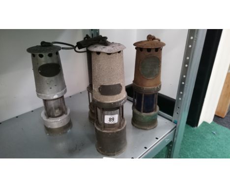 Four various vintage miner's lamps including Ackroyd & Best and Hailwood's Improved Lamp No. 18, J. H. Naylor Ltd and one oth