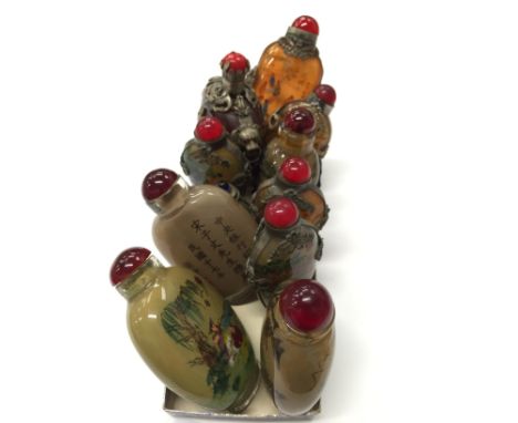 A collection of nine Chinese porcelain scent bottles modelled as various male and female figures (some signed).