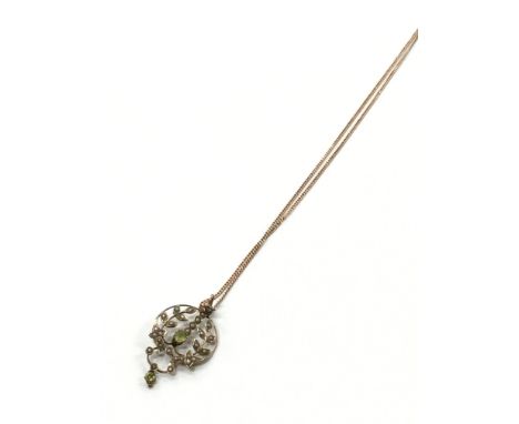 A 9 carat gold Edwardian peridot and seed pearl Lavaliere pendant on a 9 carat gold chain (slight repair to back of pendant).