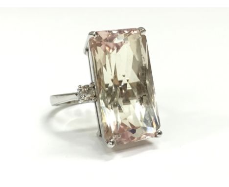 A large pink and yellow Kunzite and diamond ring, set in 18 carat white gold.
(R2)