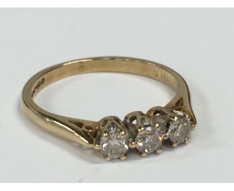 A 9 carat three stone diamond ring (1.5 grams).