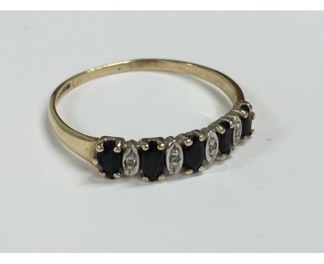 A 9 carat gold diamond and sapphire ring.