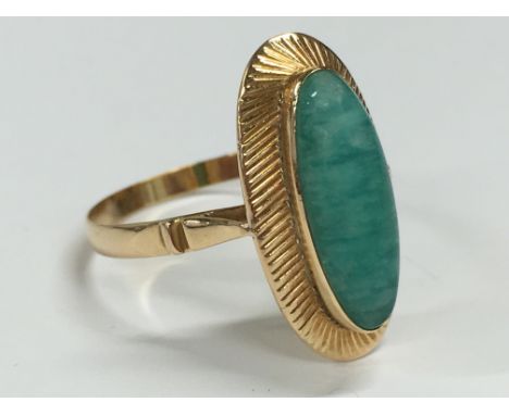 An 18 carat gold ladies dress ring set with a blue stone.