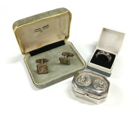 A silver coloured white metal pill box together with a pair of gold plated cuff-links and a ring.