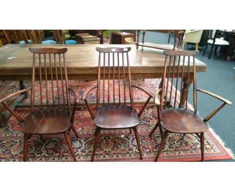 A set of three Ercol stick back Windsor chairs.