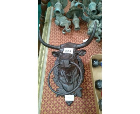 A cast iron bull with a ring through its nose.