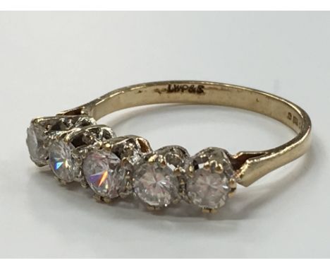 A 9 carat gold five stone ring (synthetic white stones).