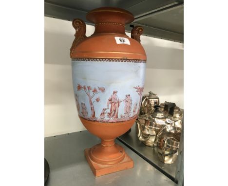 A large Watcombe Pottery terracotta urn decorated with classical figures. 