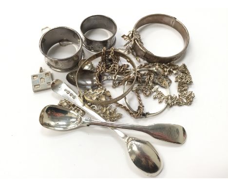 Three silver bangles, a silver napkin ring, two condiment spoons and various chains (204 grams overall).