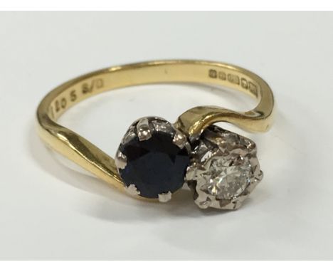 A sapphire and diamond twist ring in 18 carat yellow gold.
(R6)