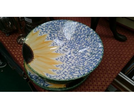 A Poole Pottery dinner set consisting of four large plates, four smaller plates and a fruit bowl in the Van Gogh Sunflower pa