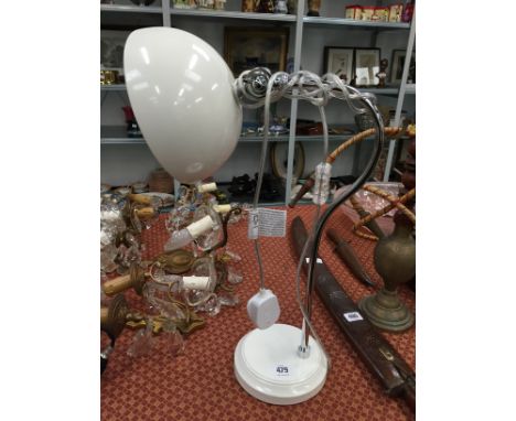 A modern chrome and metal angle poise table lamp.