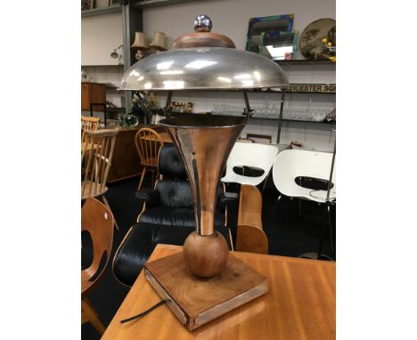 A modernist design teak and chromed table lamp of flared design.