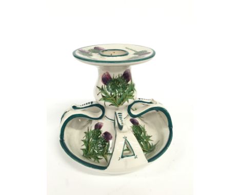 An arts and crafts Wemyss pottery chamber candlestick decorated with thistles (minor chip to side), (10cm).