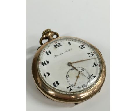 A gentleman's IWC (International Watch Company) brass cased open faced pocket watch, white enamel dial with Arabic numerals, 