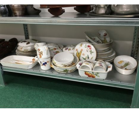 A shelf containing a large quantity of various Royal Worcester breakfast and dinner china decorated in the Evesham pattern.