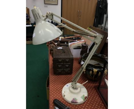 An angle poise desk lamp.