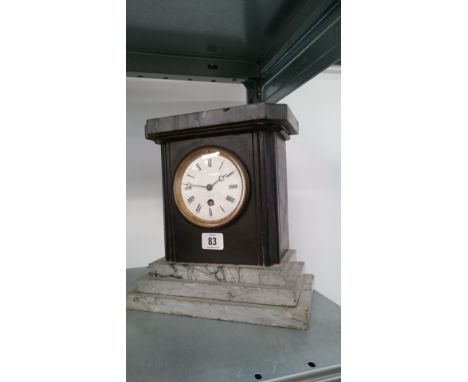 A 19th century slate and marble cased mantle clock on stepped base.