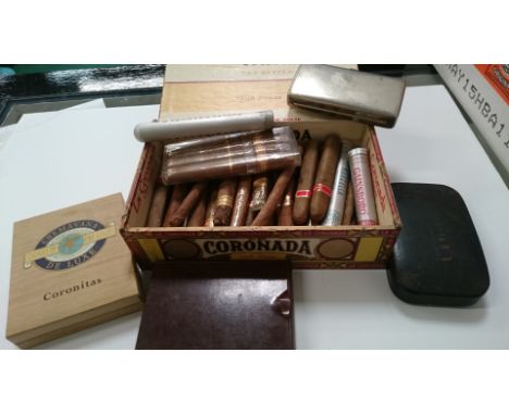 A cigar box containing various old cigars, a large 19th century black lacquer snuff box, bakelite cigar case and a chrome cig
