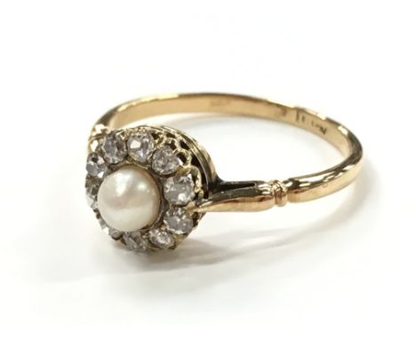 An 18 carat gold antique pearl and diamond cluster ring.